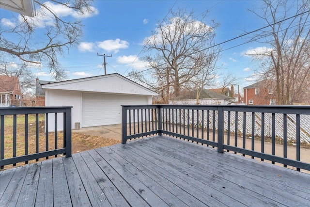 wooden deck featuring a garage and an outbuilding