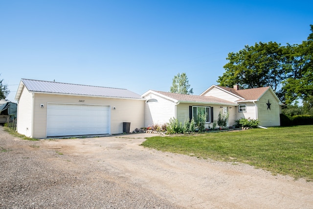 ranch-style home featuring a garage and a front lawn