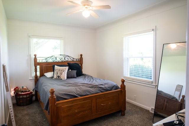 bedroom with dark colored carpet and ceiling fan