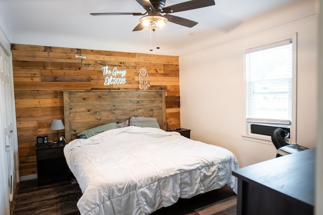 bedroom with wood walls and ceiling fan