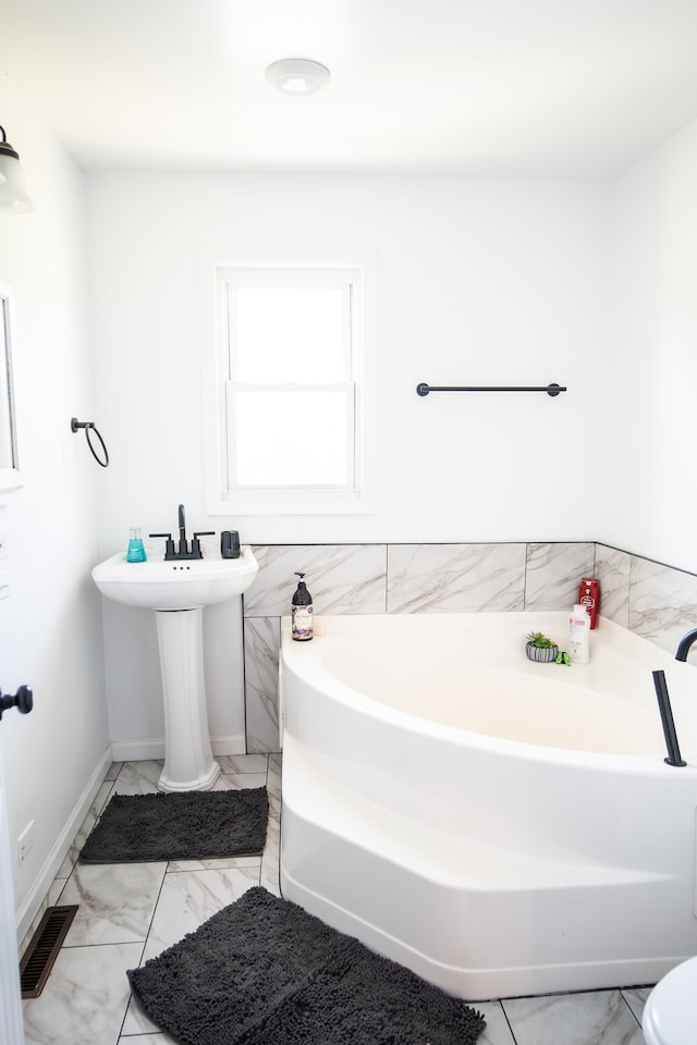 bathroom featuring a washtub