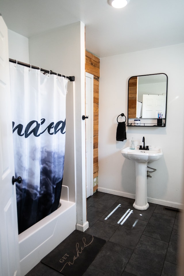 bathroom with tile patterned flooring and shower / bath combination with curtain