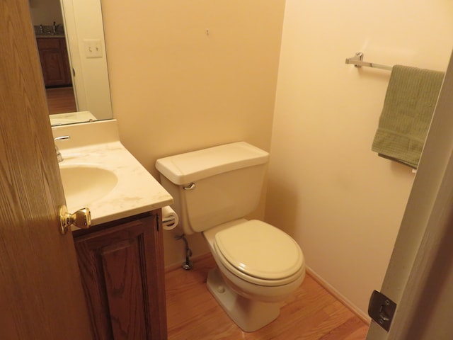 bathroom with vanity, wood-type flooring, and toilet