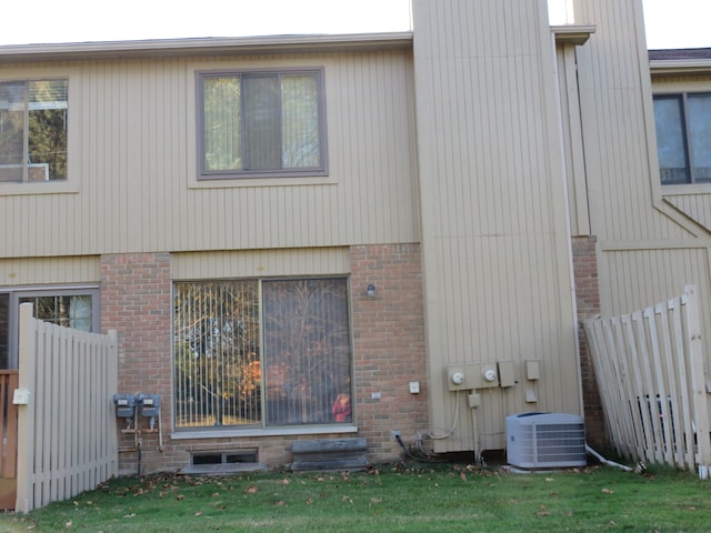 view of side of property featuring central air condition unit