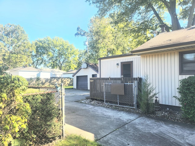 view of gate featuring an outbuilding