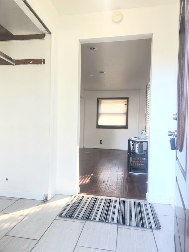 corridor with dark hardwood / wood-style floors