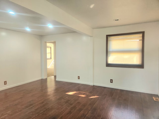 spare room with dark hardwood / wood-style floors