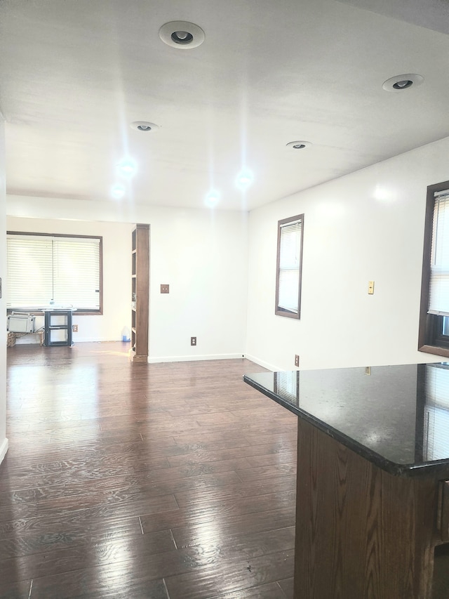 unfurnished room with dark hardwood / wood-style flooring