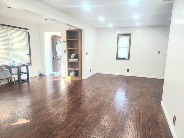 empty room with dark wood-type flooring