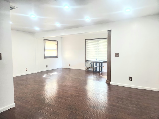 empty room with dark hardwood / wood-style floors