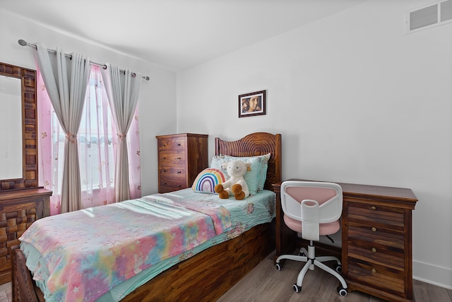 bedroom with hardwood / wood-style floors