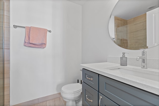 bathroom featuring tile patterned flooring, vanity, and toilet