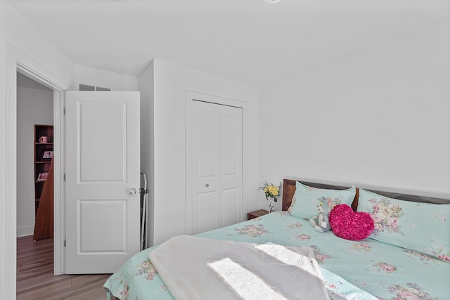 bedroom featuring a closet and light wood-type flooring