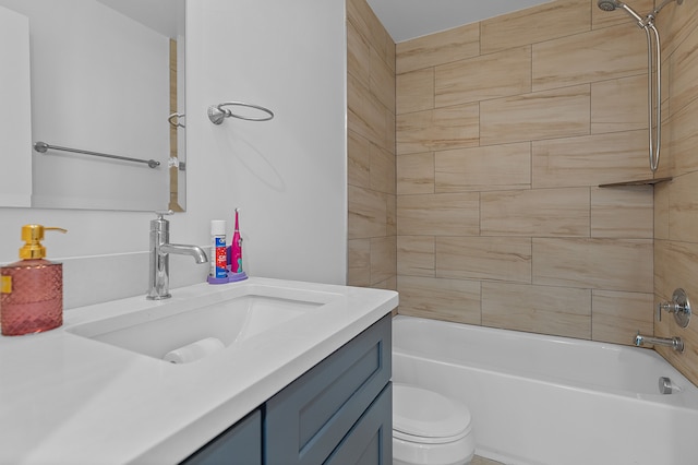 full bathroom featuring tiled shower / bath combo, toilet, and vanity