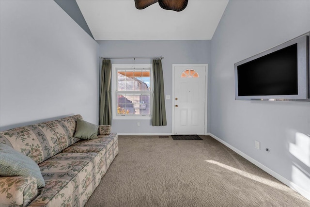 living room featuring ceiling fan, carpet floors, and lofted ceiling