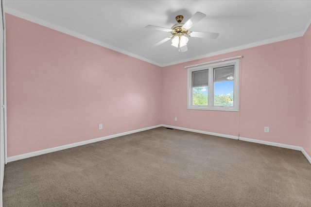 empty room with carpet flooring, ceiling fan, and crown molding