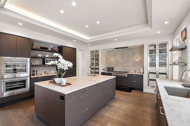 kitchen with open shelves, a sink, dark wood-type flooring, dark brown cabinets, and recessed lighting