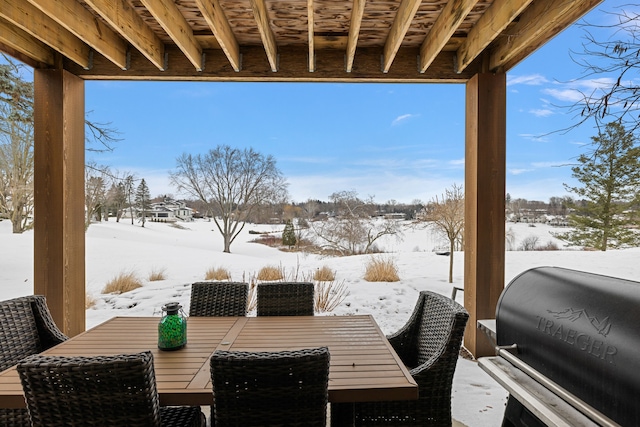 snow covered patio with a grill