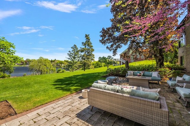 view of patio / terrace featuring outdoor lounge area and a water view