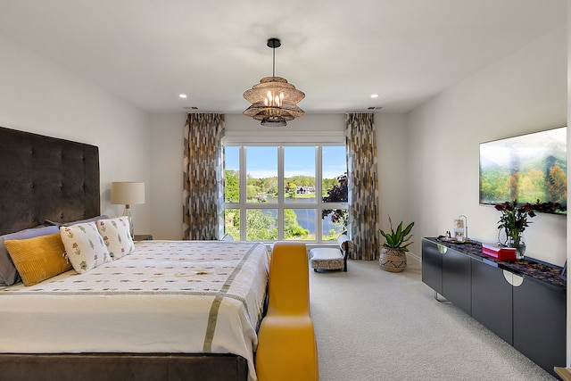 carpeted bedroom with recessed lighting and a chandelier