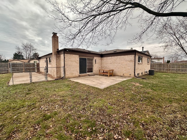 back of house featuring a lawn, cooling unit, and a patio