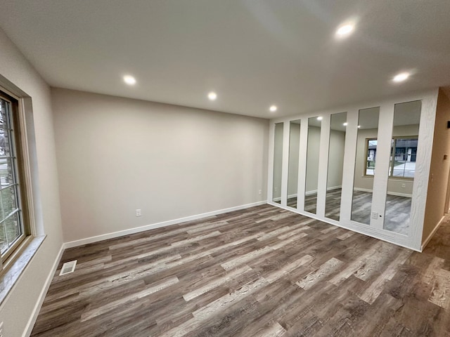 interior space with dark wood-type flooring and a healthy amount of sunlight