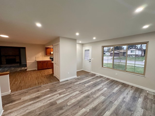 unfurnished living room with a fireplace and hardwood / wood-style floors