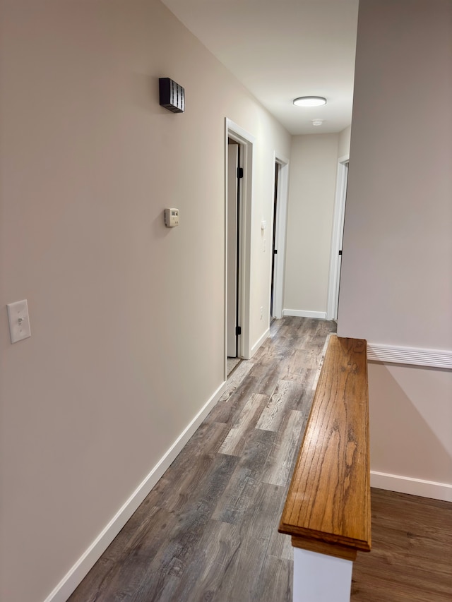 corridor with dark wood-type flooring