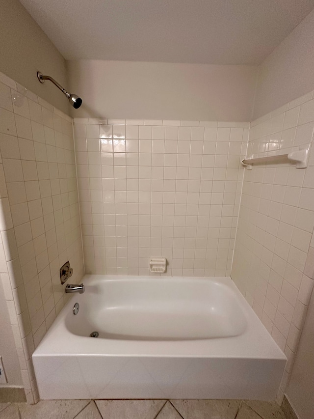 bathroom featuring washtub / shower combination and tile patterned flooring