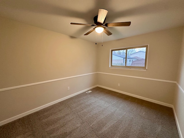 empty room with carpet flooring and ceiling fan