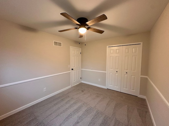 unfurnished bedroom featuring carpet flooring, ceiling fan, and a closet