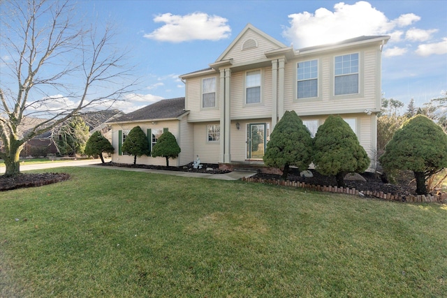 view of front facade featuring a front yard and a garage