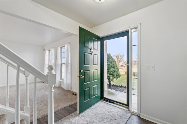 view of carpeted foyer entrance