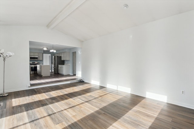 unfurnished living room featuring an inviting chandelier, lofted ceiling with beams, and hardwood / wood-style flooring