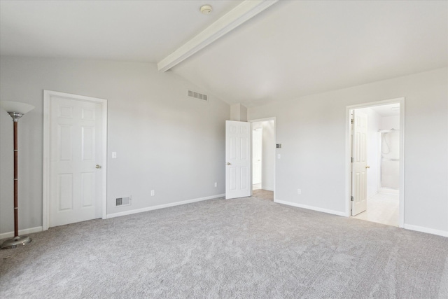 unfurnished bedroom featuring vaulted ceiling with beams, ensuite bathroom, and light carpet