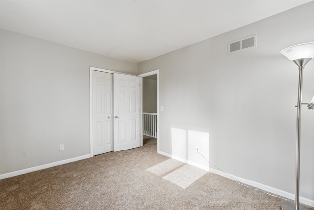 unfurnished bedroom with carpet floors and a closet