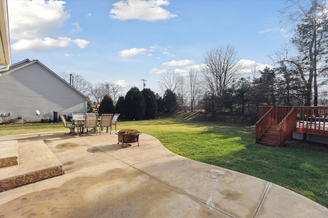 view of patio / terrace with a deck and an outdoor fire pit