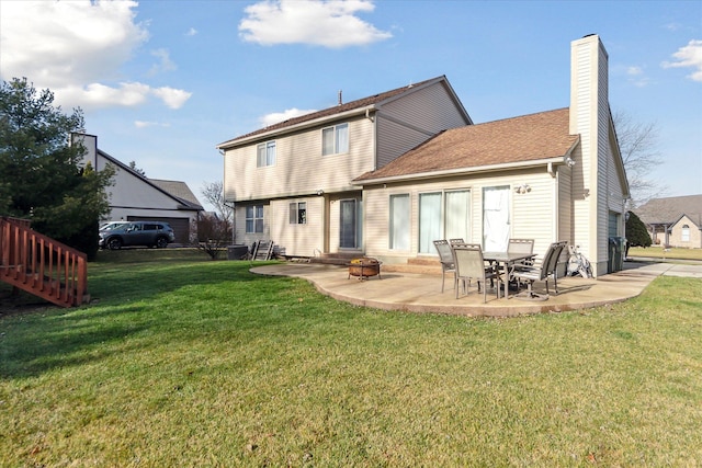 rear view of house featuring a yard and a patio area