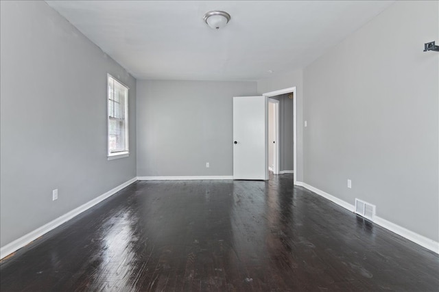 empty room with dark wood-type flooring