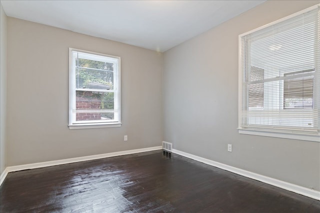 spare room featuring dark wood-type flooring