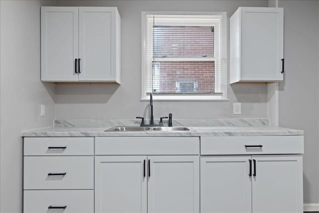 kitchen with white cabinetry and sink