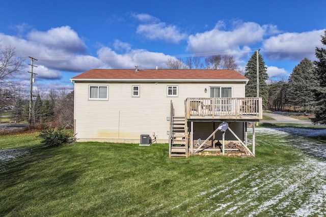 rear view of house with a lawn, cooling unit, and a deck