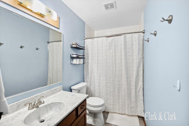 bathroom featuring vanity, toilet, and walk in shower