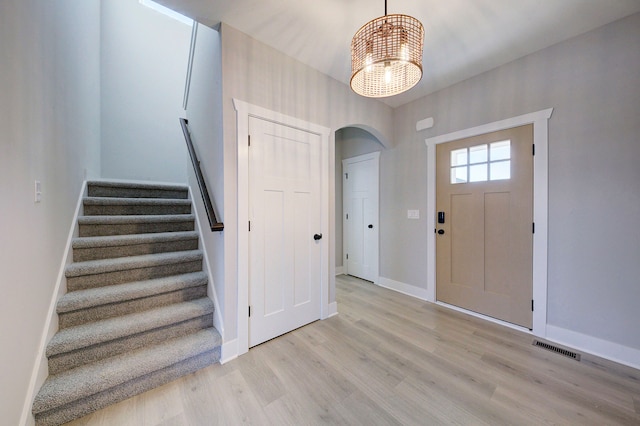 entrance foyer with an inviting chandelier and light wood-type flooring