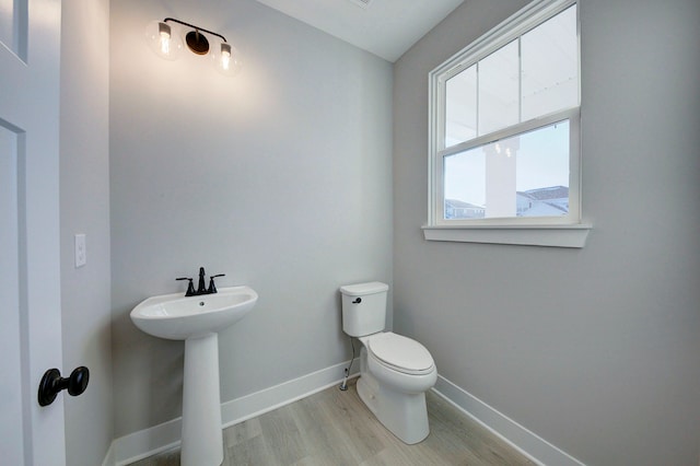 bathroom featuring hardwood / wood-style flooring, sink, and toilet