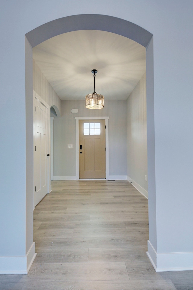 entrance foyer featuring a notable chandelier and light wood-type flooring