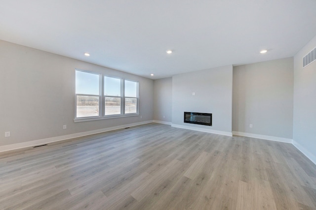 unfurnished living room with light wood-type flooring