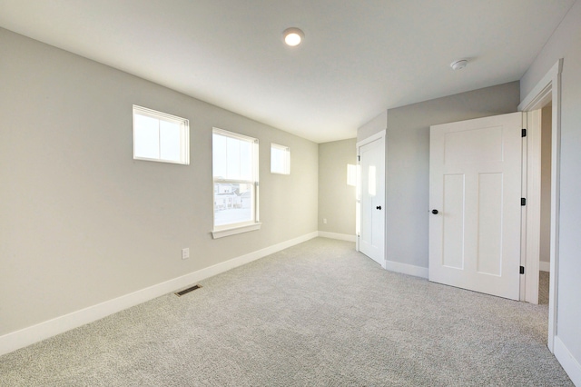 empty room featuring light colored carpet