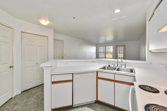 kitchen featuring white cabinets, dishwasher, kitchen peninsula, and sink