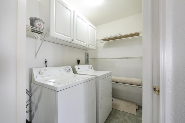 washroom with cabinets and washer and clothes dryer